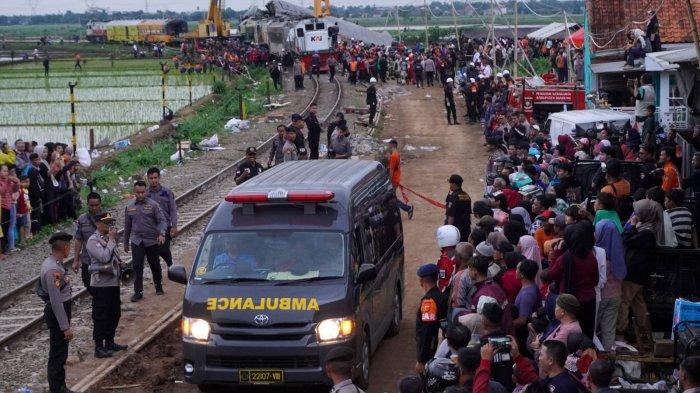 Ratusan warga menyaksikan mobil ambulan membawa mayat korban tabrakan kereta api (KA) Turangga dan KA Lokal Bandung Raya di Desa Cikuya, Kecamatan Cicalengka, Kabupaten Bandung, Jawa Barat, Jumat (5/1/2024).