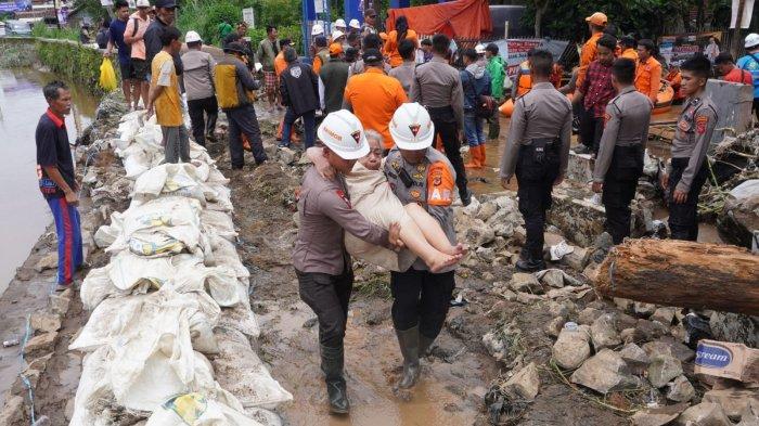 Petugas mengevakuasi warga yang rumahnya terendam air dan material sampah di sekitar lokasi tanggul Sungai Cigede yang jebol, di Kampung Lamajang Peuntas, Desa Citeureup, Kecamatan Dayeuhkolot, Kabupaten Bandung, Jawa Barat, Jumat (12/1/2024).
