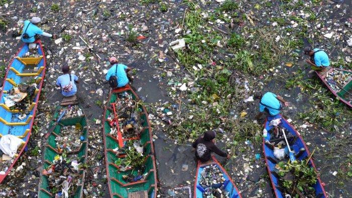 Sejumlah pemulung menggunakan perahu kayu mengais sampah plastik yang bisa dijual dan memungut sampah lainnya untuk dibuang saat bersama petugas gabungan dan masyarakat bergotong royong membersihkan sampah di Sungai Citarum, Desa Selacau, Kecamatan Batujajar, Kabupaten Bandung Barat, Sabtu (14/6/2024).