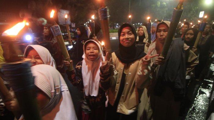 Warga dari DKM Al- Fattah Kota Cimahi melakukan pawai obor saat memperingati Tahun Baru Islam ( 1 Muharram 1446 H ) saat melintas di Jalan Gatot Subroto, Cimahi.Sabtu (6/7). Kegiatan pawai obor ini diikuti anak-anak, remaja dan orang tua dengan melantunkan solawatan.