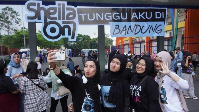 Penggemar Sheila On 7 (Sheila Gank) berfoto di area luar stadion sebelum menyaksikan konser Sheila On 7 bertajuk 