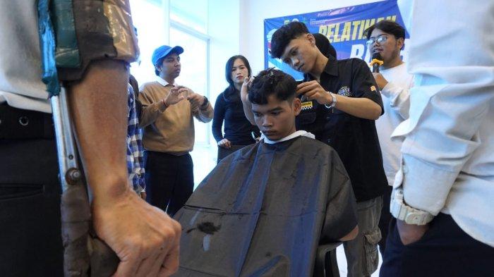 Instruktur dari Lembaga Pelatihan Kerja (LPK) Putri, Irfan Abu Yahya (31) dan Nabil Teizar Pratama (21) memberikan pelatihan barber atau pangkas rambut kepada sejumlah penyandang disabilitas di Kantor Dinas Ketenagakerjaan (Disnaker) Kota Bandung, Jawa Barat, Selasa (29/10/2024).
