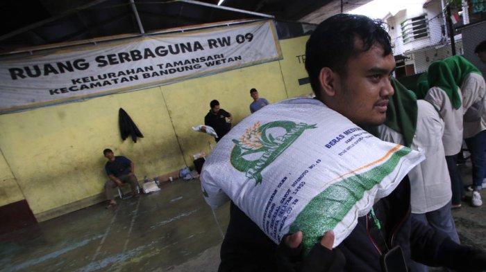 Warga penerima manfaat menerima beras saat penyaluran program Bantuan Pangan Cadangan Beras Pemerintah (CBP) Tahap III Tahun 2024 di bawah flyover Mochtar Kusumaatmadja (Pasupati), Kelurahan Tamansari, Kecamatan Bandung Wetan, Kota Bandung, Jawa Barat, Selasa (11/12/2024).
