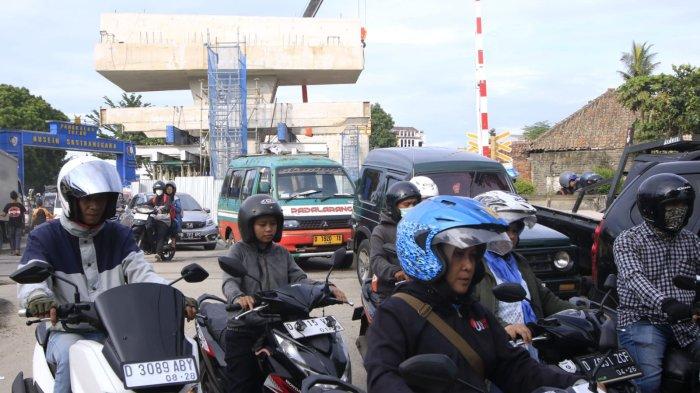 Kepadatan kendaraan bermotor melintasi perlintasan sebidang kereta api di kawasan proyek Flyover Nurtanio, Jalan Abdurahman Saleh - Garuda, Kota Bandung, Jawa Barat, Selasa (17/12/2024).