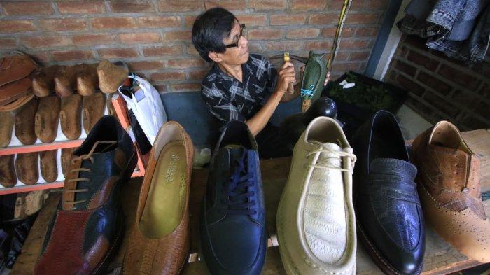 Perajin mengerjakan pembuatan sampel sepatu yang terbuat dari bahan baku utama olahan limbah kulit kaki (ceker) ayam di rumah produksi Hirka Shoes, Gang Subur, Jalan Mohammad Toha, Kelurahan Cigereleng, Kecamatan Regol, Kota Bandung, Jawa Barat, Selasa (17/12/2024).