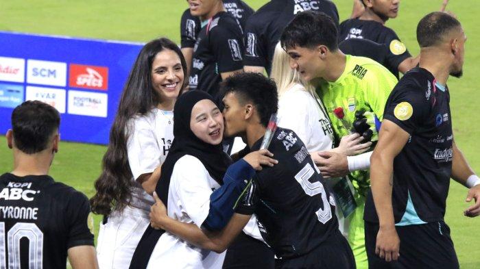 Pemain Persib, Rachmat Irianto dan Kevin Mendoza memeluk istrinya saat momen merayakan Hari Ibu sebelum pertandingan Persib Bandung menghadapi Persita Tangerang pada lanjutan Liga 1 2024-2025 di Stadion Gelora Bandung Lautan Api (GBLA), Kota Bandung, Jawa Barat, Minggu (22/12/2024).