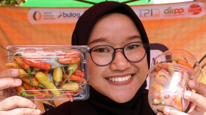 Penjaga stan memperlihatkan cabai rawit yang sudah dikemas siap jual pada gelaran Stabilisasi Pasokan dan Harga Pangan (SPHP) di halaman Kantor Dinas Ketahanan Pangan dan Pertanian (DKPP) Kota Bandung, Jalan Arjuna, Kota Bandung, Jawa Barat, Rabu (15/1/2025).