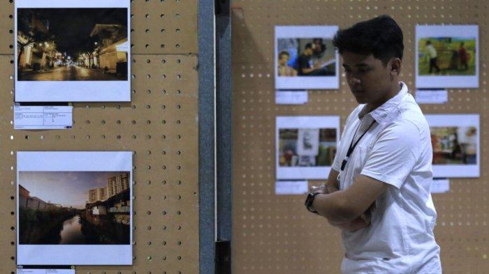 Pengunjung mengamati salah satu foto pada gelaran Pameran Foto Urban Visual: Kampung Braga bertema 