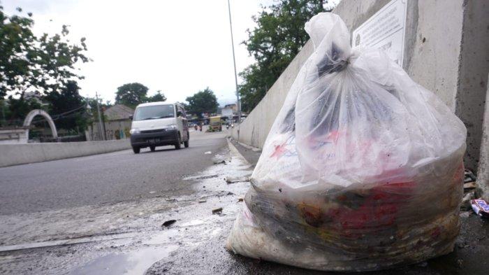 Kendaraan bermotor melintasi sampah di Flyover Ciroyom, Kelurahan Ciroyom, Kecamantan Andir, Kota Bandung, Jawa Barat, Jumat (24/1/2025).