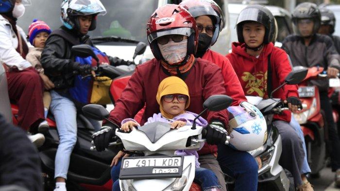Pemudik bermotor membawa anak kecil melintas di Jalan Nagreg, Kabupaten Bandung, Jawa Barat, Sabtu (29/3/2025).