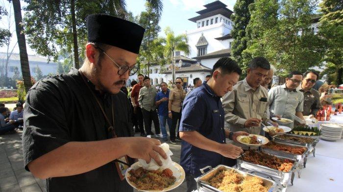 Pegawai Pemda Provinsi Jawa Barat antre makan gratis seusai Halalbihalal Idul Fitri 1446 H bersama Gubernur Jawa Barat, Dedi Mulyadi, di halaman Gedung Sate, Kota Bandung, Jawa Barat, Selasa (8/4/2025).