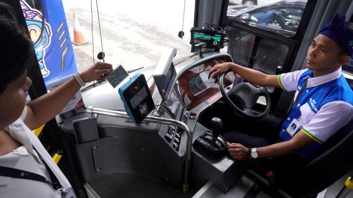 Petugas melakukan uji coba penggunaan Kartu Multi Trip (KMT) usai peluncuran Cashless Payment KMT di Bus Metro Jabar Trans, di Jalan Kebon Kawung depan Stasiun Bandung, Kota Bandung, Jawa Barat, Kamis (19/6/2025).