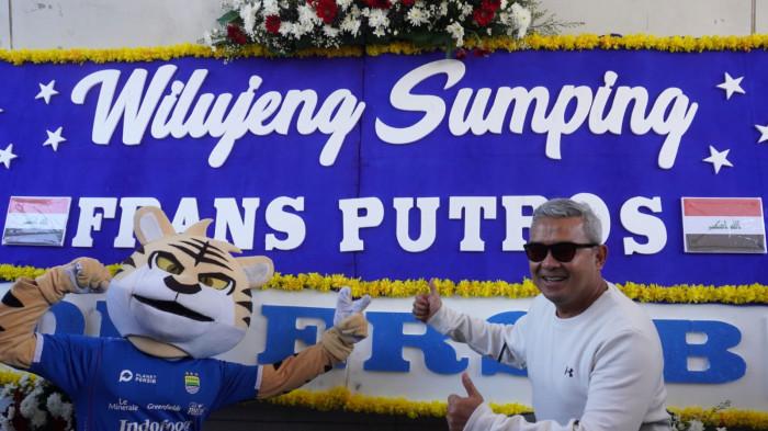 Wali Kota Bandung, Muhammad Farhan didampingi maskot Si Maung Bandung (Simba) memperkenalkan pemain anyar Persib Bandung, Frans Putros, yang namanya tertera pada karangan bunga bertuliskan Wilujeng Sumping di Persib, di bawah Jembatan Penyeberangan Orang (JPO), Jalan Asia Afrika, Kota Bandung, Jawa Barat, Rabu (16/7/2025).