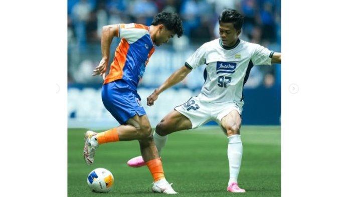 Pemain Port FC, Asnawi Mangkualam (kiri) berebut bola dengan pemain Persib Bandung.