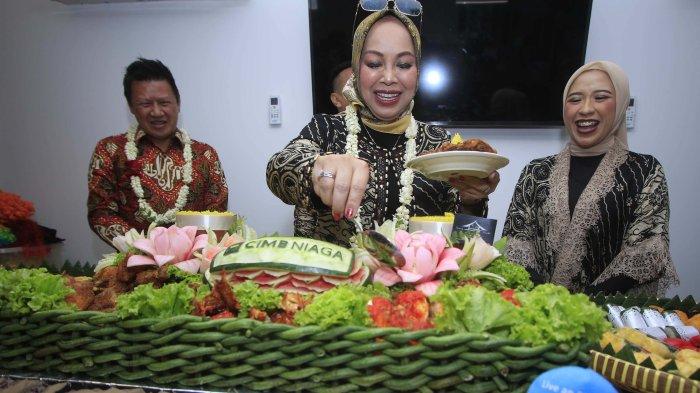 Kepala Wilayah Jakarta A dan Kalimantan CIMB Niaga, Evita Barliana  disaksikan  (tengah) disaksikan  Kepala Jaringan dan Perbankan Digital CIMB Niaga, Budiman Tanjung, dan Kepala Cabang Area - Jakarta A, Lilik Handoyo memotomg tumpeng saat acara peresmian  Kantor cabang CIMB Niaga Digital Branch Karawang - Rolling Hills Pacific Plaza Boulevard , Jumat ( 14/6 ).  Kehadiran kantor cabang ini diharapkan dapat memenuhi kebutuhan nasabah perbankan  tinggi untuk menopang pertumbuhan ekonomi nasional.