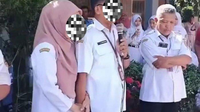Sepasang guru SMAN 1 Bukateja, Kabupaten Purbalingga, Jawa Tengah, bergandeng tangan saat menghadapi unjuk rasa siswa buntut kemelut Seleksi Nasional Berdasarkan Prestasi (SNBP), Rabu (5/2/2025).