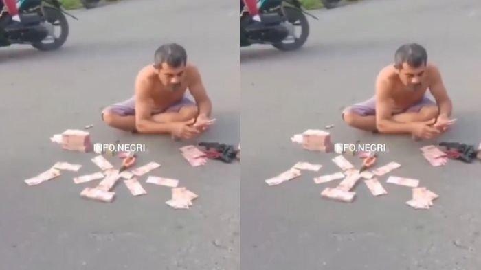 Sebuah video memperlihatkan aksi pria menumpuk uang Rp350 juta di tengah jalan beredar viral di media sosial