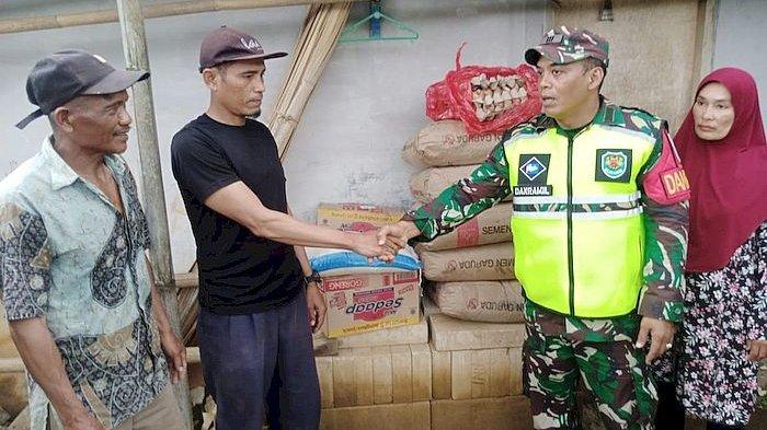 Personel TNI AD menyerahkan bantuan semen dari Kodim 0622/Kab Sukabumi kepada warga terdampak gempa bumi di Kampung Pasir Masigit, Desa Cipeuteuy, Kecamatan Kabandungan, Jumat (8/12/2023)