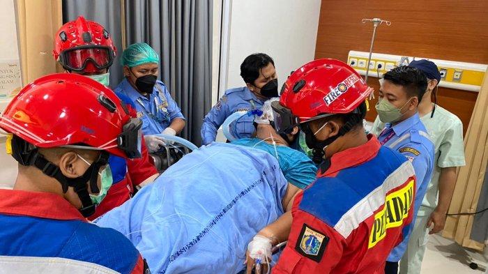 Personel Damkar Jakarta Timur dan AGD Dinas Kesehatan DKI Jakarta saat proses evakuasi Ario Gunawan Chaz, Rabu (12/7/2023)