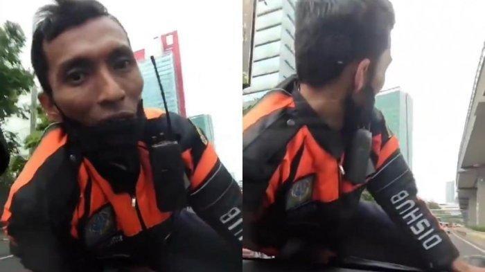 Seorang petugas Dinas Perhubungan (Dishub) Jakarta bernama Yan Iskandarsyah naik di kap mobil