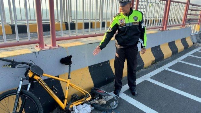 KORBAN TABRAK LARI: Kondisi sepeda jenis MTB berwarna kuning milik korban Taufik Hidayat (57), warga Jalan Rambutan, Desa Banyuajuh, Kecamatan Kamal, Bangkalan, setelah diserempet kendaraan pikap misterius di pinggir jalur mobil Jembatan Suramadu KM 3400 tujuan Surabaya, Minggu (13/7/2025). Korban meregang nyawa di lokasi kejadian. (TRIBUN MADURA/ISTIMEWA)