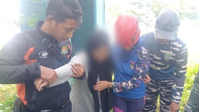 DITEMUKAN SELAMAT - Petugas gabungan membawa Pipit, ibu dari dua bocah kakak beradik yang ditemukan tewas tenggelam di Pantai Sigandu Batang, Rabu (30/7/2025). Saat ini Pipit yang ditemukan dalam kondisi selamat itu berada di Polres Batang untuk jalani pemeriksaan.