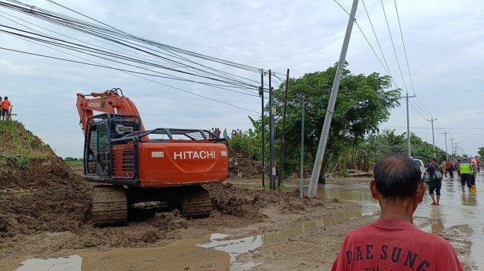 Jalan Purwodadi-Semarang di Desa Tinanding, Kecamatan Godong, Kabupaten Grobogan yang ditutup karena banjir kini mulai dibersihkan, Rabu (22/1/2025)