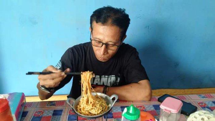 Pembeli saat menikmati mie ayam berwadahkan wajan mini di kedai mie ayam Admi. Karena keunikan penyajiannya, kedai mie ayam Admi jadi buruan pembeli dari berbagai daerah.