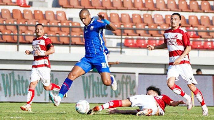 Pemain Arema FC (biru) berduel dengan pemain Madura United (merah) di Stadion Kapten I Wayan Dipta Bali pada Jumat (26/7/2024).