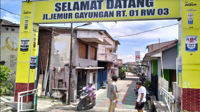 Pembebesan Lahan - Warga Bundaran Dolog, di Kampung Jemur Gayungan, Kelurahan Gayungan, Kecamatan Gayungan, Surabaya, saat melintas di pintu masuk kampung, Kamis (18/4/2024).