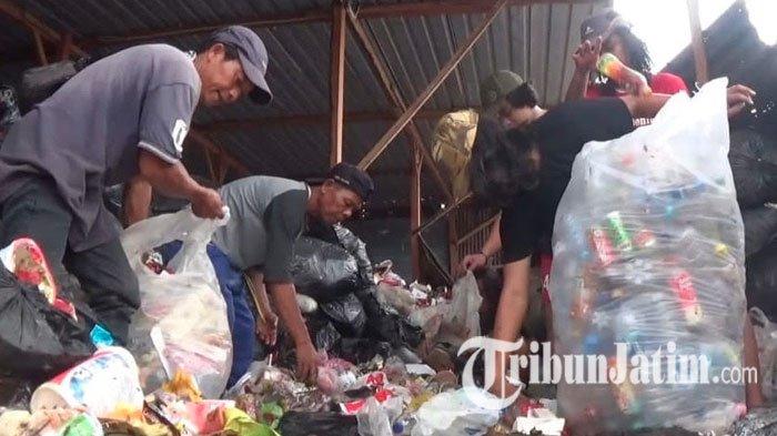 Bripka Seladi saat mengajari para siswa SMA Kolese De Brito memulung sampah.