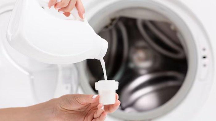 Close-up woman pouring detergent with washing machine