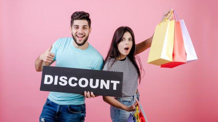 Happy smiling handsome couple man and woman with discount sign and colorful shopping bags