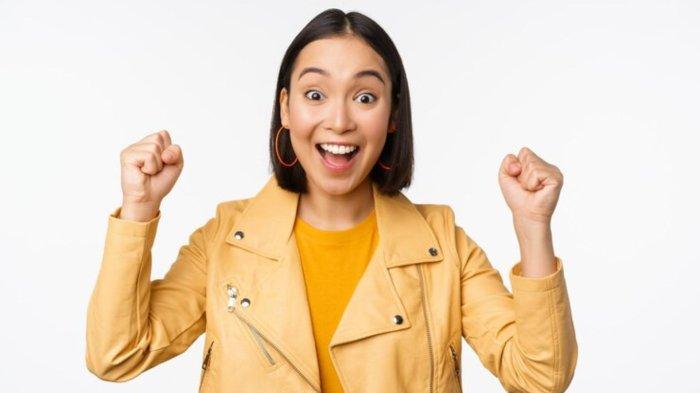 Image of asian woman dancing and smiling happy celebrating victory triumphing standing over white background