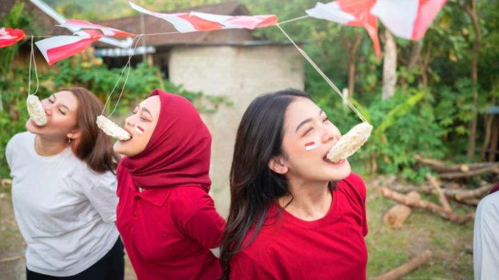 A group of women are eating creakers contest