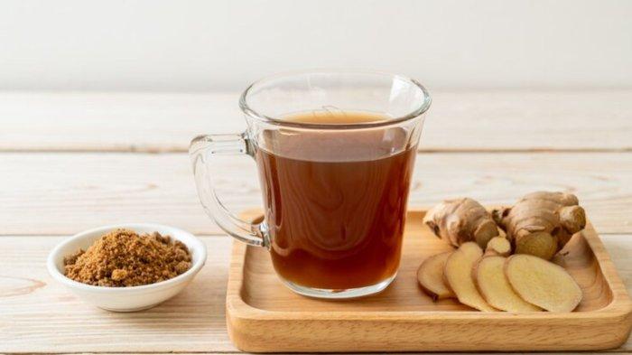 Hot and sweet ginger juice glass with ginger roots - Healthy drink style