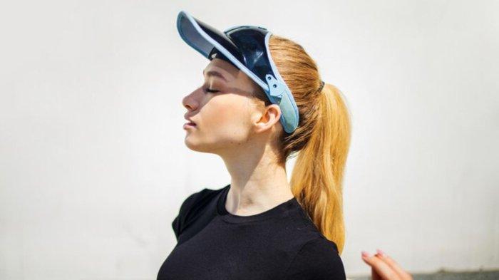 Fashion blonde woman in a blue cap lifestyle portrait
