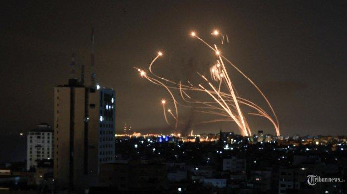 Salvo roket ditembakkan oleh militan Palestina dari Gaza diadang rudal Israel dari sistem rudal pertahanan Iron Dome di atas kota Netivot di Israel selatan pada 8 Oktober 2023. 