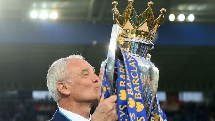 Claudio Ranieri mencium trofi Liga Inggris atau Premier League yang dimenangkannya bersama Leicester City. 