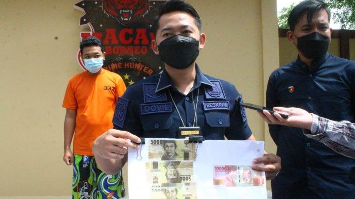 Kanit Jatanras Macan Borneo Polresta Samarinda, Ipda Dovi Eudy saat memperlihatkan barang bukti uang palsu dari kedua pelaku.
TRIBUNKALTIM.CO/ MOHAMMAD FAIROUSSANIY