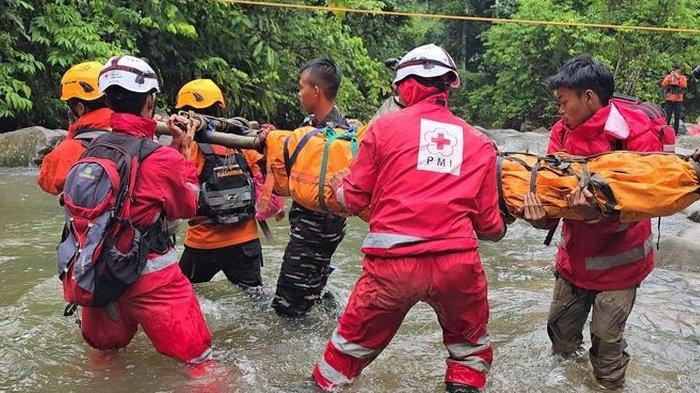 Tim SAR gabungan menandu korban terakhir melewati sungai dalam longsor tambang emas ilegal di Nagari Sungai Abu, Kecamatan Hiliran Gumanti, Kabupaten Solok, Sumatera Barat, Minggu (29/9/2024).