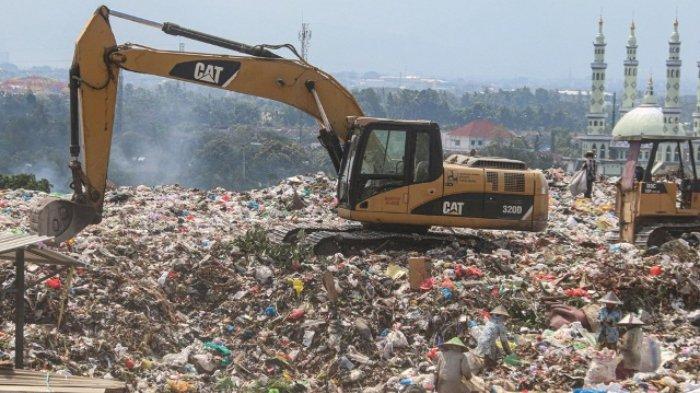 Proses pemilihan sampah menggunakan alat berat di TPA Kebon Kongok.