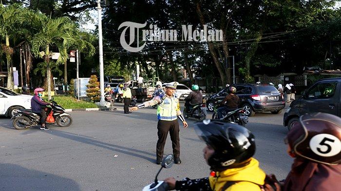 Petugas Kepolisian mengatur arus lalu lintas di Jalan Mongonsidi, Kecamatan Medan Polonia, Kota Medan, Selasa (7/11). Pemko Medan melalui Dinas Perhubungan (Dishub) Kota Medan melakukan rekayasa arus lalu lintas selama pekerjaan intersection di Jalan Sudirman dan mengalihkannya ke jalur alternatif, yaitu membuka dua jalur melalui Jalan Kapten Patimura lalu ke barat Jalan Mongonsidi.