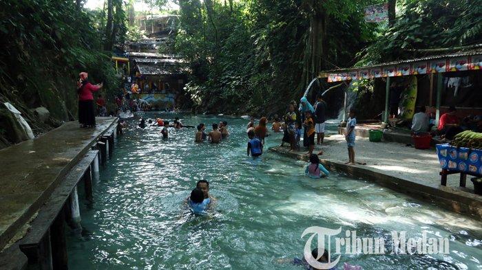 Sejumlah wisatawan menikmati suasana objek wisata Pemandian Bah Damanik, Simalungun, Minggu (14/2/2021). Wisata pemandian tersebut menjadi salah satu pilihan utama masyarakat untuk memanfaatkan liburan Imlek.
