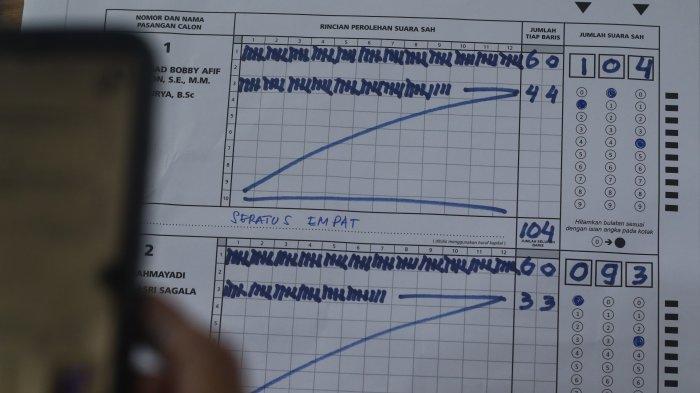 Petugas (Kelompok Penyelenggara Pemungutan Suara) KPPS melakukan penghitungan surat suara Pilgub Sumut, di TPS 15, Kompleks Taman Setia Budi Indah, Medan, Rabu (27/11/2024). Di TPS 15, pasangan Bobby-Surya unggul memeroleh 104 suara dari pasangan Edy-Hasan yang memeroleh 93 suara dari 204 suara pemilih.