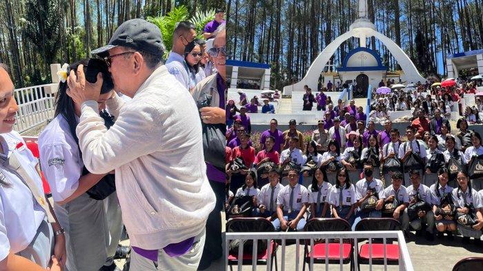 PAKET KASIH - Tokoh masyarakat Sumut, RE Nainggolan, mengecup kening pelajar di Salib Kasih, Taput, usai memberikan Paket Kasih Polda Sumut dalam acara Napak Tilas Paskah Nasional 2025. Acara berlangsung tanggal 24-26 April 2025, Polda Sumut memberikan 5000 paket untuk disalurkan oleh Panitia Paskah Nasional.