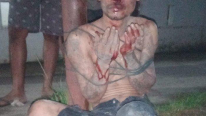 Tampang pelaku babak belur dipukuli warga dan diikat di tiang listrik.