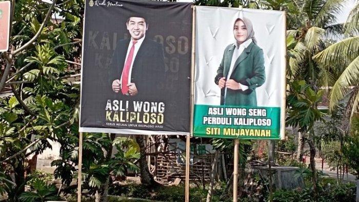 Banner mantan pasangan suami istri yang bertarung di Pilkades Desa Kaliploso pada Pilkades serentak Banyuwangi, Jawa Timur, Rabu (25/10/2023).