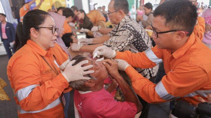 Wakil Presiden Direktur PT Agincourt Resources, Ruli Tanio, (kanan) meneteskan obat mata ke pasien yang telah menjalani operasi katarak gratis Tambang Emas Martabe, Senin (13/11/2023). Sebanyak 1.310 mata berhasil dioperasi pada tahun ini.