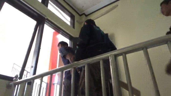 PELAKU PEMBUNUHAN - Gu (44) saat tiba di Mapolres Rejang Lebong, Bengkulu pada Kami (8/5/2025). Polres Rejang Lebong telah menetapkan Gu sebagai tersangka dalam kasus pembunuhan terhadap istri sirinya, Euis Setia (42), dan anak tirinya, Gaidah Marwa Wijaya (14).